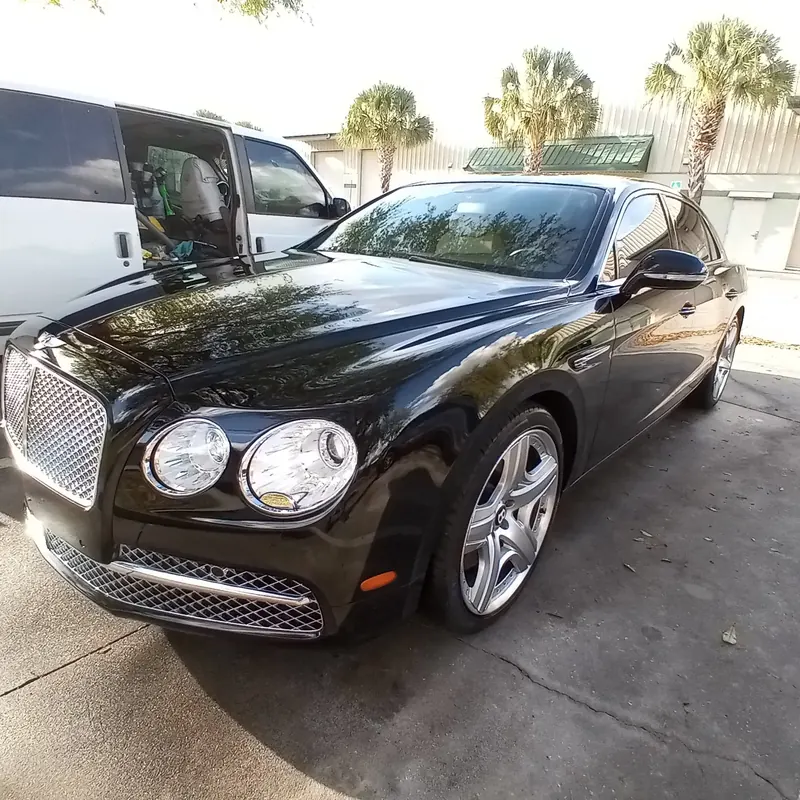 Black Bentley after a mobile wash