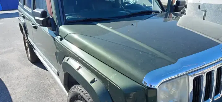 Glossy green Jeep Commander hood after ceramic coating