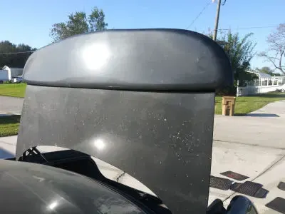 Dull, faded black trunk spoiler before detailing