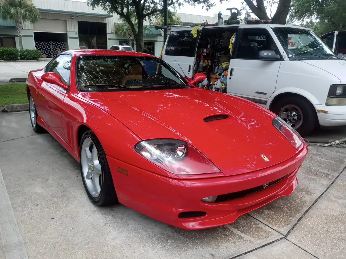 Glossy red Ferrari 550 parked beside the Amazing Mobile Detailing work van, freshly detailed