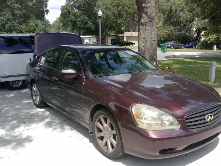 Maroon sedan with dull paint before paint correction