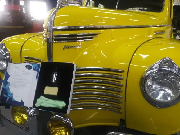 Yellow vintage Plymouth truck with a ceramic coating kit on the hood