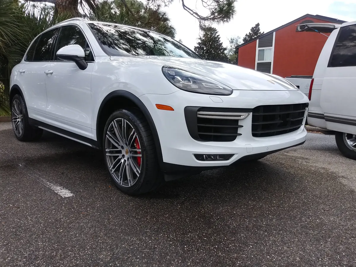 White Porsche Cayenne gleaming after a wash and wax