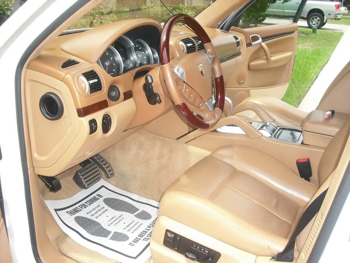 Spotless tan leather interior of a Porsche Cayenne after detailing
