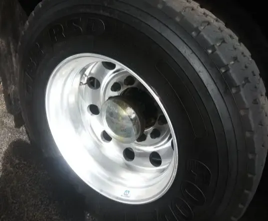 Polished aluminum truck wheel on a dark tire