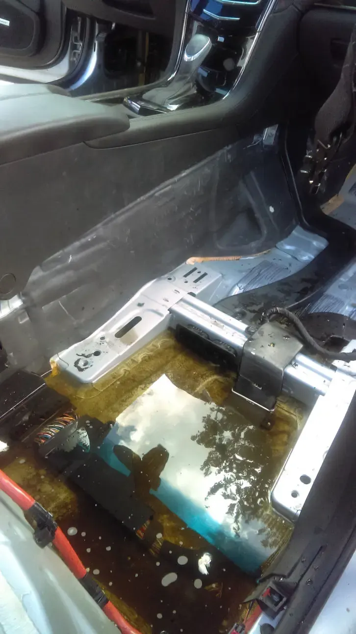 Car interior with seats removed exposing the floor during water extraction